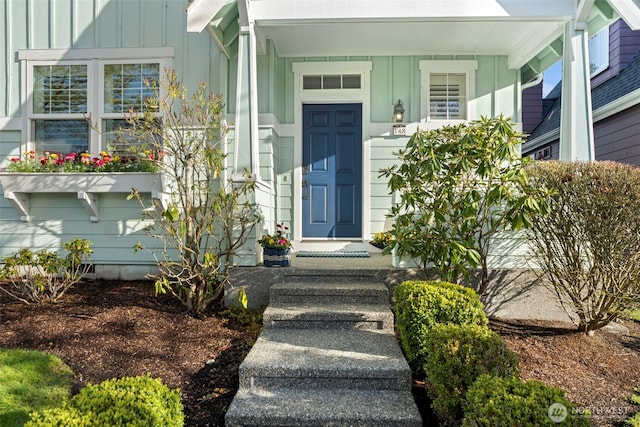 doorway to property featuring board and batten siding