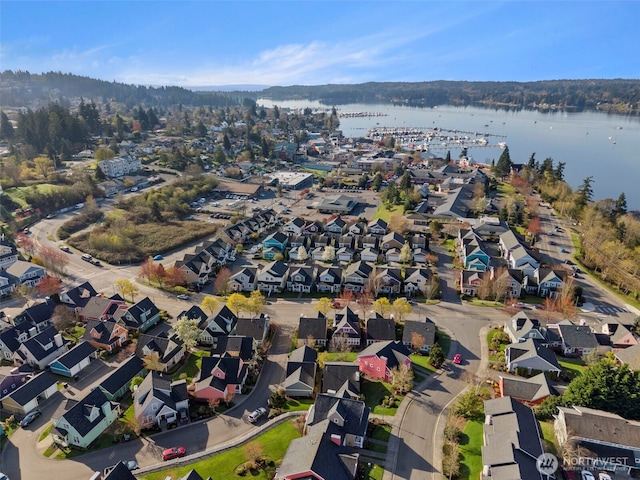 drone / aerial view featuring a water view and a residential view