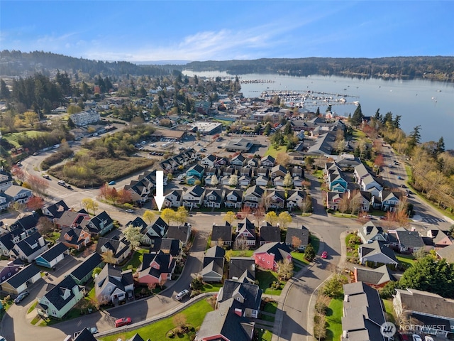 birds eye view of property featuring a water view and a residential view