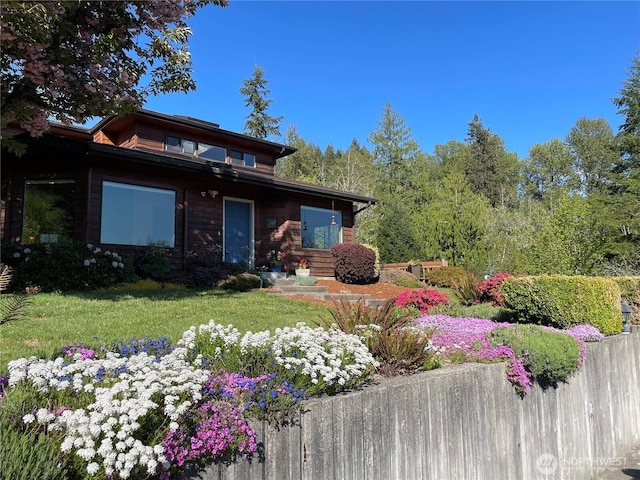 view of front of home featuring a front lawn and fence