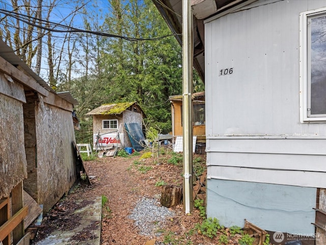 view of yard featuring an outbuilding and a shed
