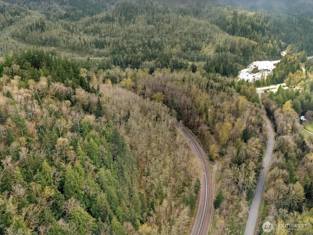 drone / aerial view featuring a forest view