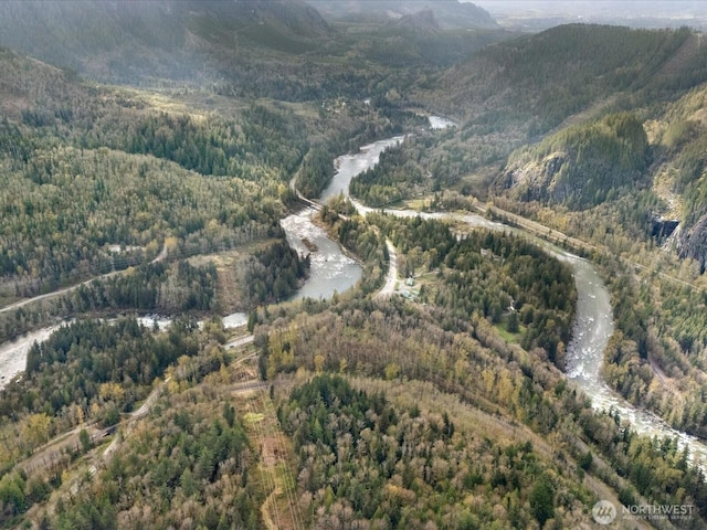 aerial view with a wooded view and a mountain view