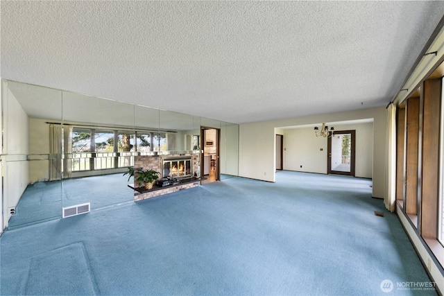 478 SW Judson Dr, Oak Harbor, WA 98277 - interior space featuring carpet, visible vents, a textured ceiling, and an inviting chandelier