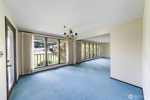 478 SW Judson Dr, Oak Harbor, WA 98277 - unfurnished room with a chandelier, carpet, and a textured ceiling