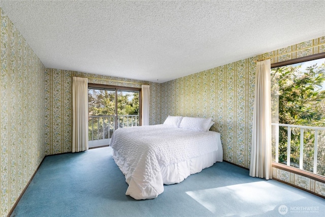 478 SW Judson Dr, Oak Harbor, WA 98277 - bedroom featuring a textured ceiling, wallpapered walls, and carpet floors