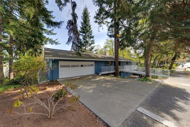 478 SW Judson Dr, Oak Harbor, WA 98277 - ranch-style home featuring an attached garage, a chimney, concrete driveway, and fence