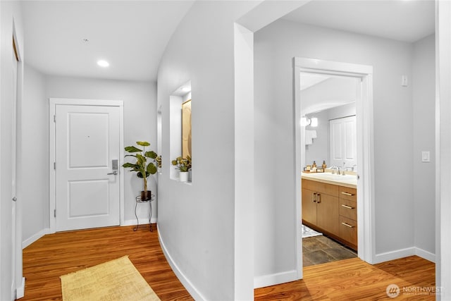 5615 24th Ave NW Unit 24, Seattle, WA 98107 - corridor with baseboards, wood finished floors, recessed lighting, and a sink