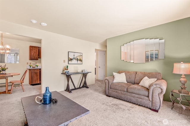 carpeted living room with a notable chandelier