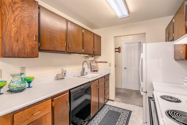 kitchen with white appliances, light countertops, a sink, and brown cabinets