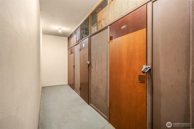 hall with concrete flooring