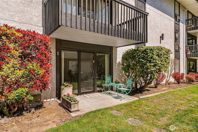 exterior space with a patio and stucco siding