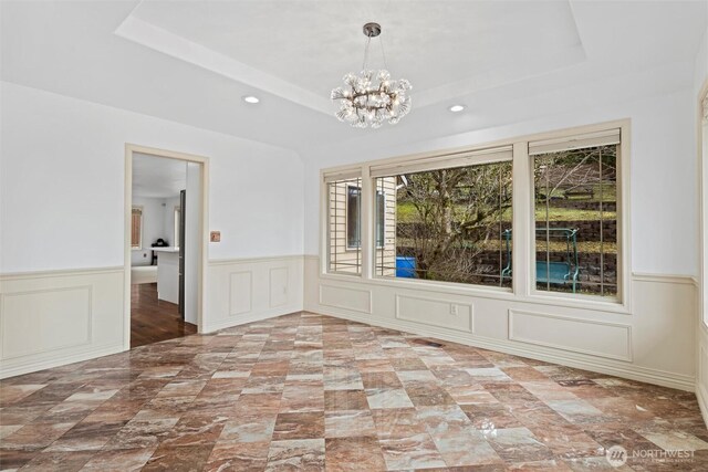 13923 SE 79th Dr, Newcastle, WA 98059 - empty room with a chandelier, recessed lighting, a tray ceiling, and a wainscoted wall