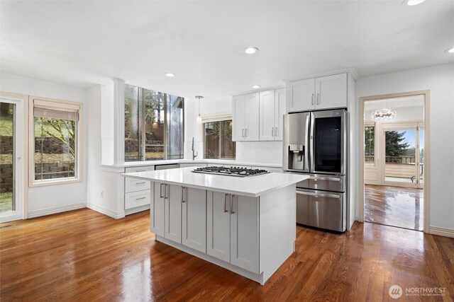 13923 SE 79th Dr, Newcastle, WA 98059 - kitchen with a healthy amount of sunlight, a center island, light countertops, and appliances with stainless steel finishes