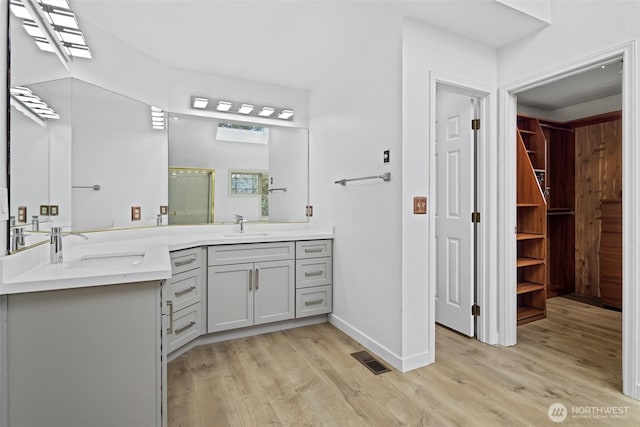 13923 SE 79th Dr, Newcastle, WA 98059 - full bath featuring a shower stall, double vanity, a sink, and wood finished floors