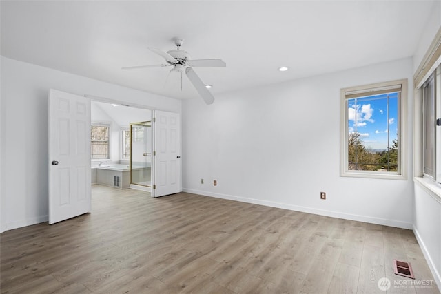 13923 SE 79th Dr, Newcastle, WA 98059 - unfurnished bedroom with visible vents, baseboards, recessed lighting, connected bathroom, and light wood-style flooring