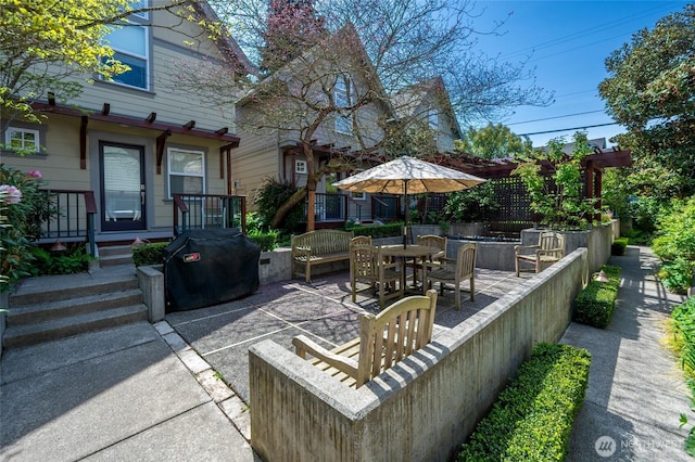 view of patio with outdoor dining space and area for grilling
