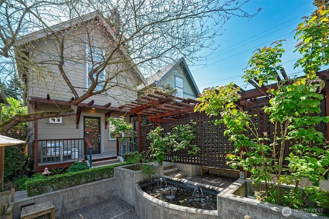 back of house with a pergola