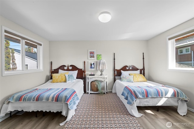 bedroom featuring wood finished floors and baseboards