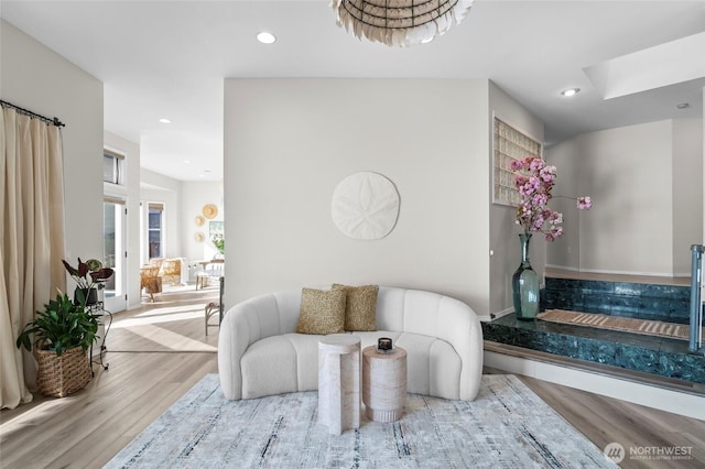 living area with wood finished floors and recessed lighting