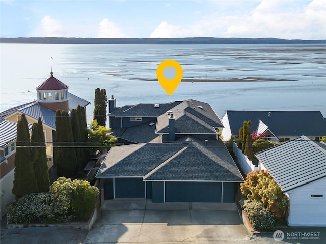 birds eye view of property with a water view