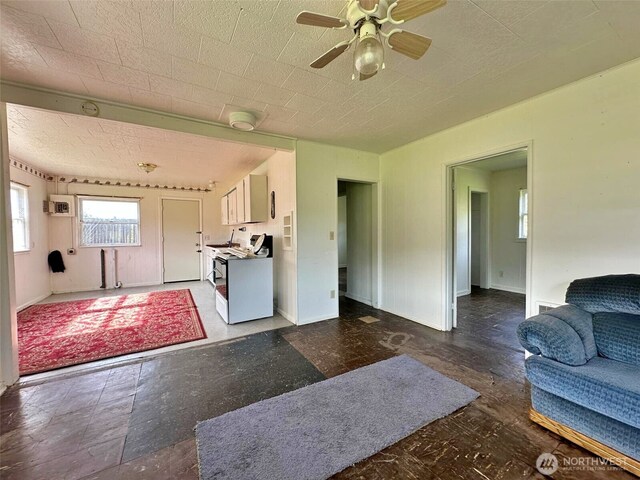 107 Martin Rd, Glenoma, WA 98336 - living area featuring baseboards, a ceiling fan, and a wall mounted AC