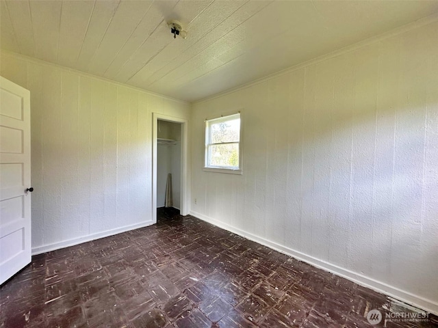 107 Martin Rd, Glenoma, WA 98336 - unfurnished bedroom with ornamental molding, baseboards, dark floors, and a closet