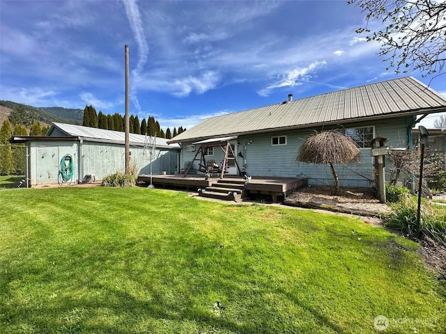 107 Martin Rd, Glenoma, WA 98336 - back of property featuring a deck, metal roof, and a lawn