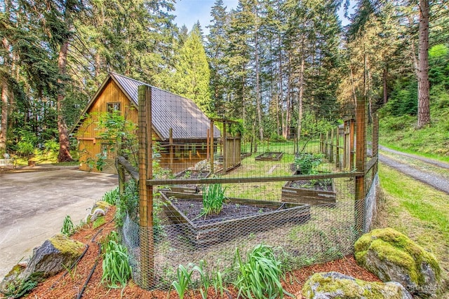 exterior space featuring a garden, driveway, and a garage