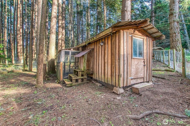 view of outbuilding featuring an outbuilding and fence