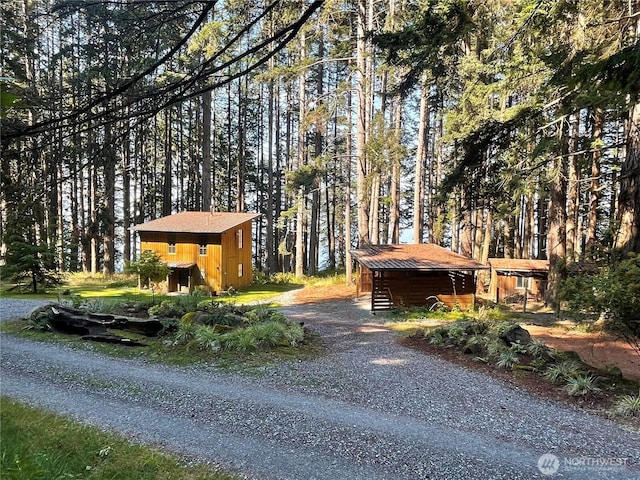 view of property exterior featuring an outbuilding and a shed