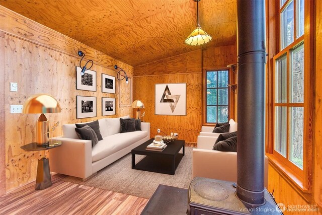 104 Barn Owl Trl, Orcas Island, WA 98245 - living room featuring lofted ceiling, wood finished floors, a wood stove, and wood walls