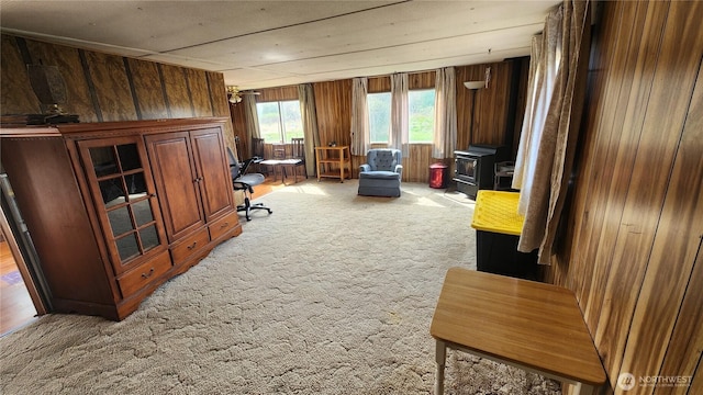 8458 Shintaffer Rd, Blaine, WA 98230 - home office with light colored carpet, wooden walls, and a wood stove