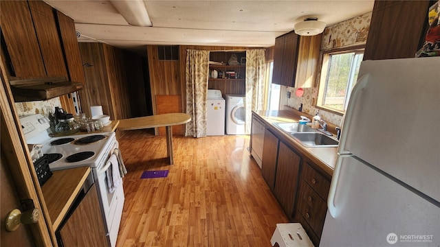 8458 Shintaffer Rd, Blaine, WA 98230 - kitchen with visible vents, washer and dryer, a sink, light wood-type flooring, and white appliances