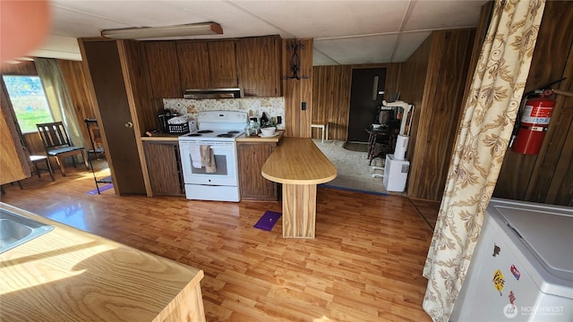 8458 Shintaffer Rd, Blaine, WA 98230 - kitchen featuring range hood, light wood-type flooring, wooden walls, white electric range, and decorative backsplash