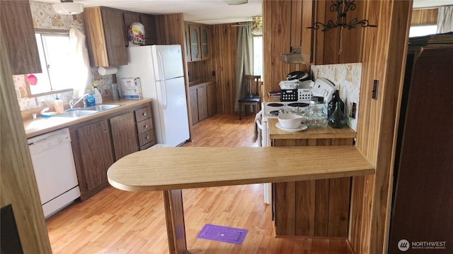 8458 Shintaffer Rd, Blaine, WA 98230 - kitchen featuring white appliances, tasteful backsplash, light wood-type flooring, light countertops, and a sink