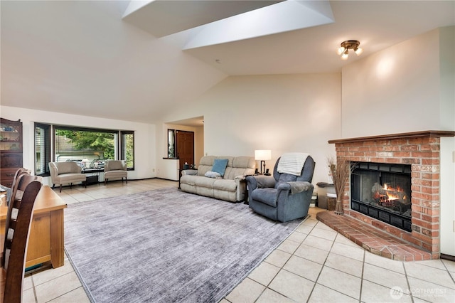 living room with light tile patterned floors, vaulted ceiling, and a brick fireplace