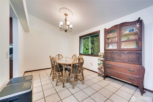 dining room with baseboards, a chandelier, and light tile patterned flooring