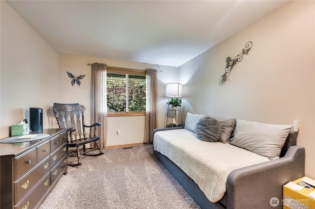 living area with light carpet, visible vents, and baseboards