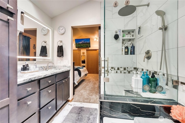bathroom with ensuite bath, vanity, a tile shower, and lofted ceiling