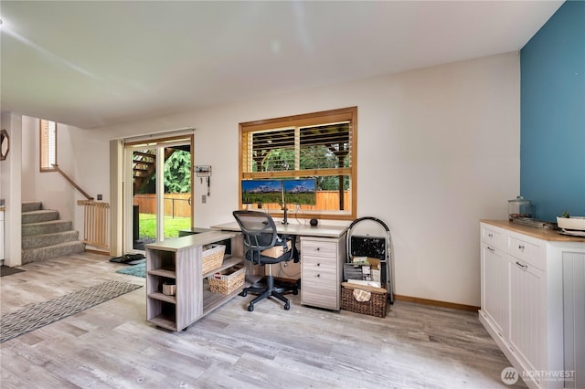 office space featuring baseboards and light wood-type flooring