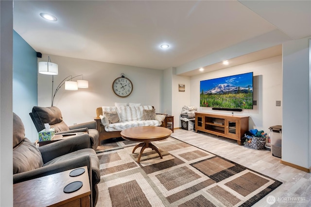 living area featuring wood finished floors and recessed lighting