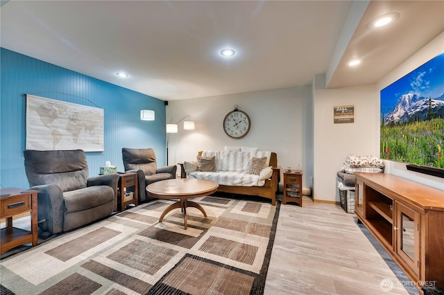 living area featuring wood finished floors, baseboards, and recessed lighting
