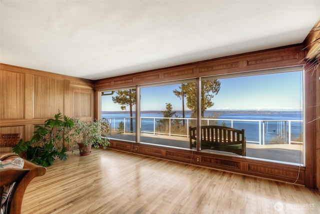 unfurnished sunroom with a water view