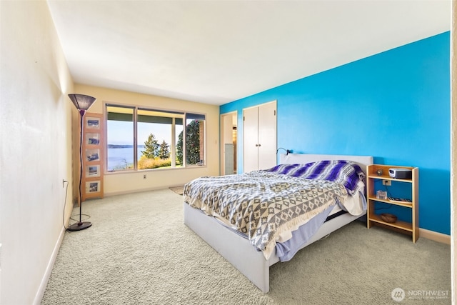 carpeted bedroom featuring baseboards