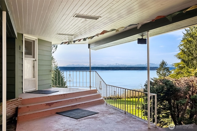 view of patio with a water view