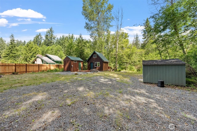 112 Mountain View Dr N, Ashford, WA 98304 - view of yard with an outdoor structure, fence, and a storage unit