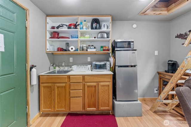 112 Mountain View Dr N, Ashford, WA 98304 - kitchen featuring light countertops, light wood finished floors, a sink, and stainless steel appliances