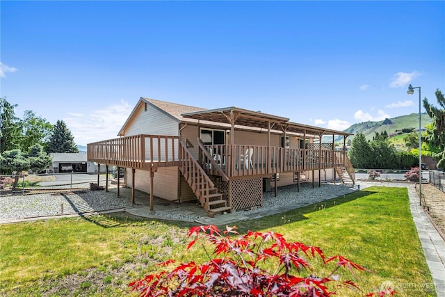 back of property with stairs and a deck with mountain view