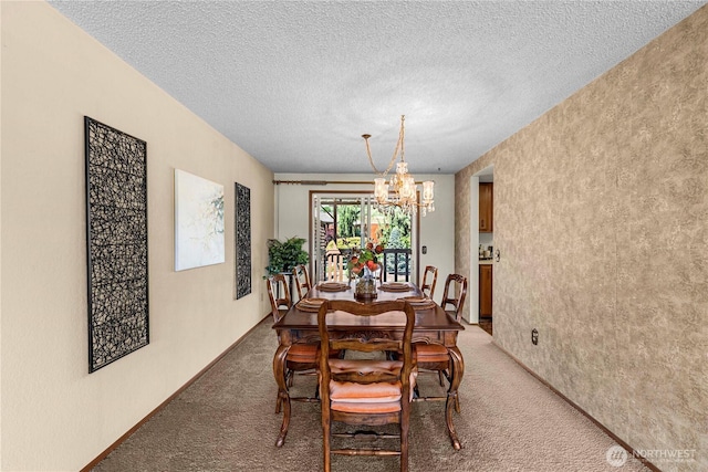 dining room featuring light colored carpet, a chandelier, and a textured ceiling